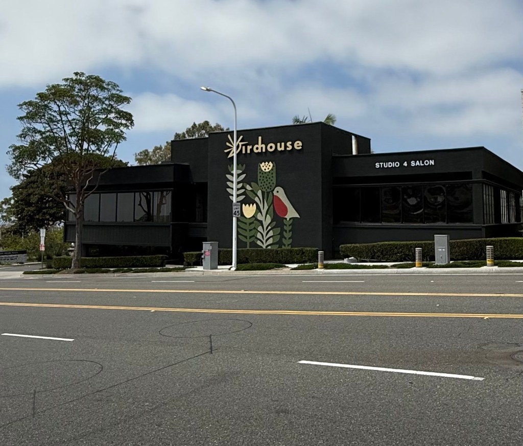 The Birdhouse mural and gold sign on Avocado Avenue, home of Coastal Polish & Beauty in Newport Beach